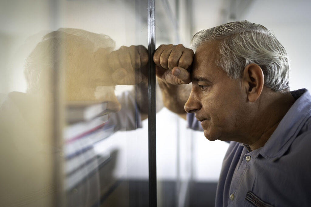 Worried senior businessman feeling stressed at work