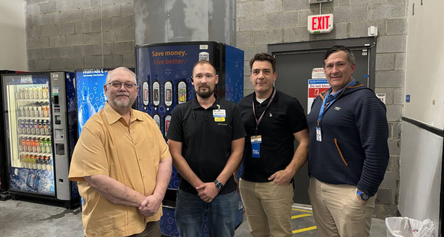 An R3 clinician stands with three Wal-Mart employees after the devastating hurricane.