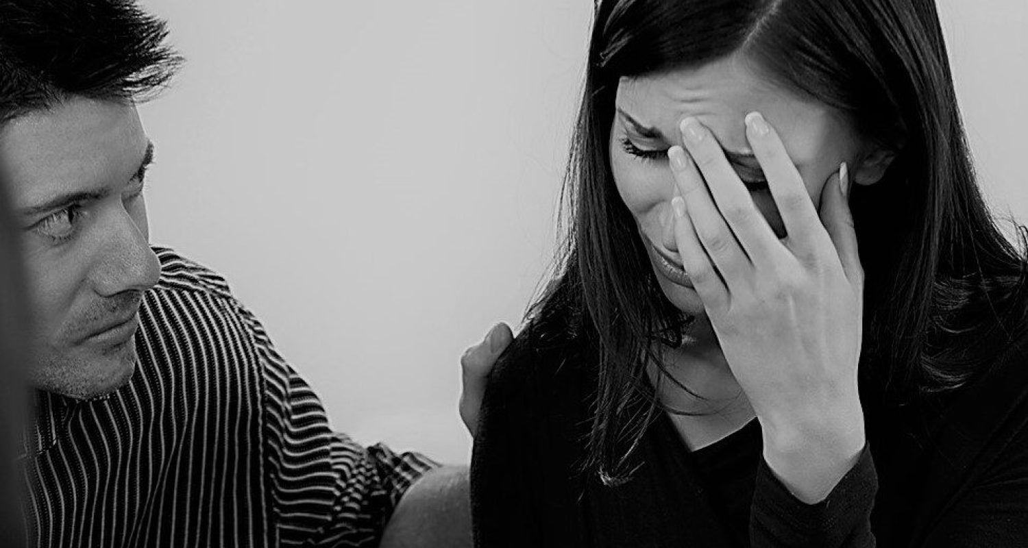 A woman sharing her emotions in a support group.