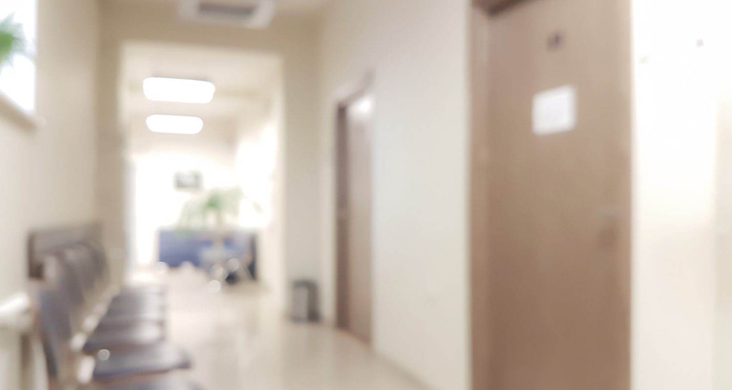 Blurred background waiting room in the doctor's office - chairs in the hallway and the door to the doctor's office