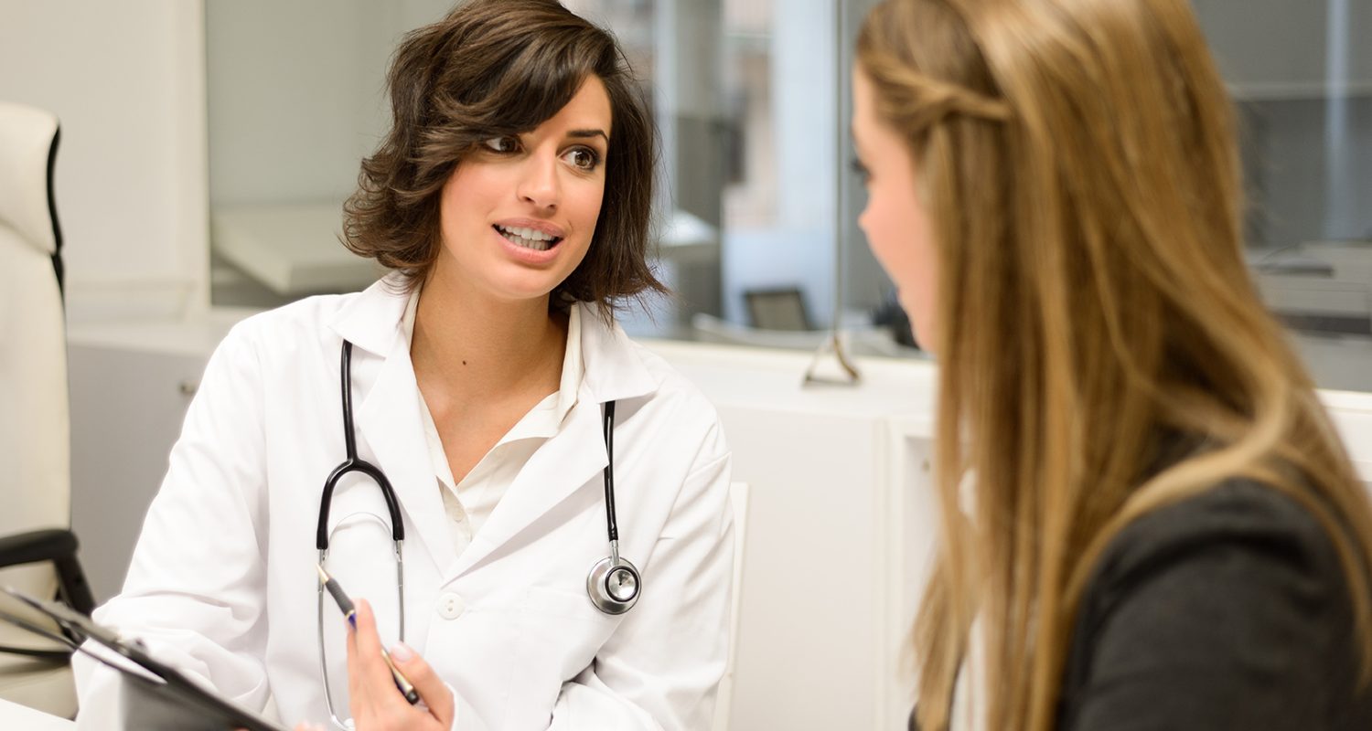 Female doctor explaining diagnosis to her female patient