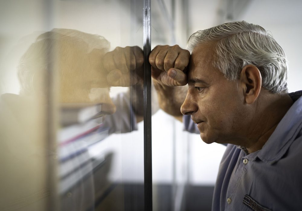 Worried senior businessman feeling stressed at work