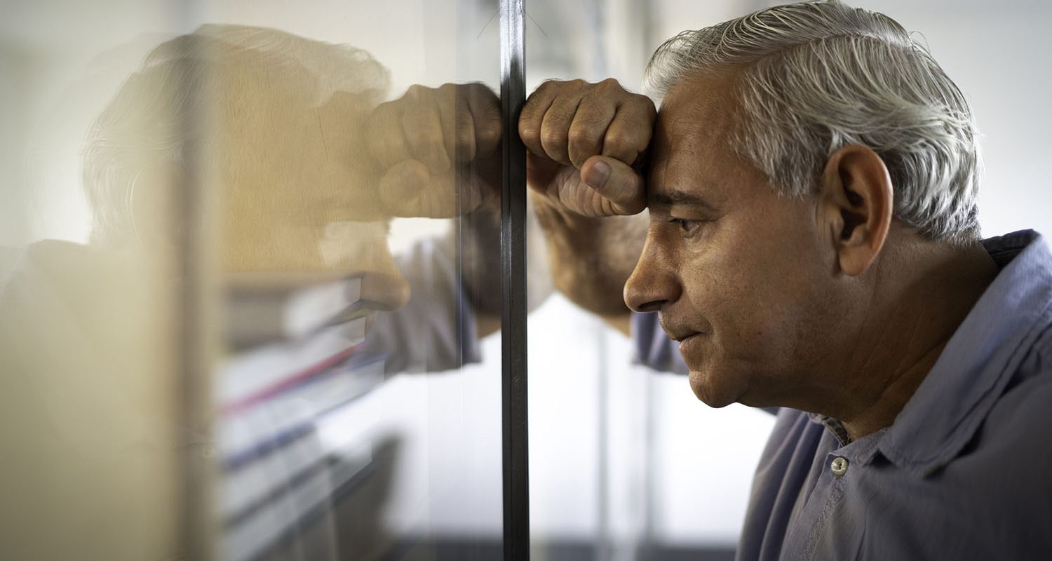 Worried senior businessman feeling stressed at work