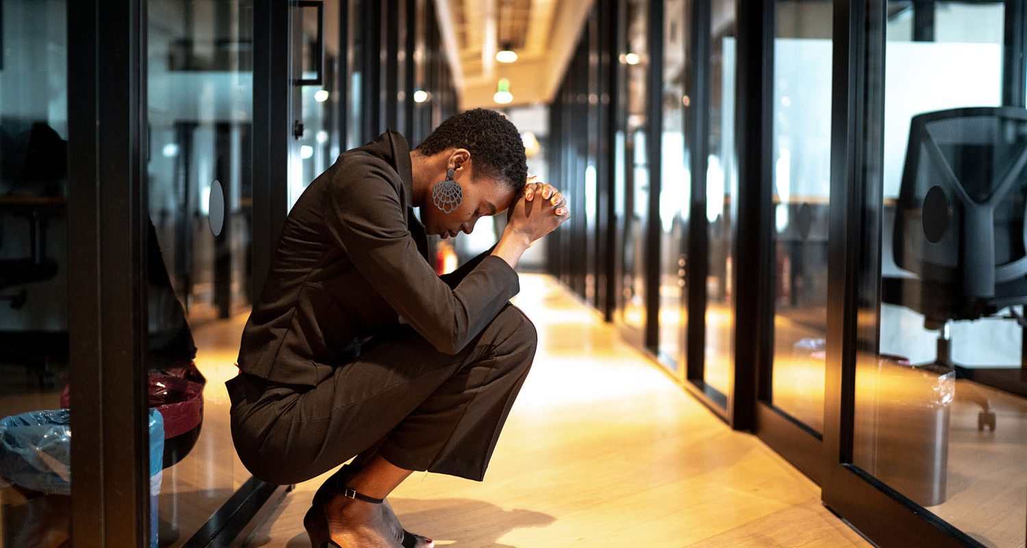 Worried young businesswoman at corridor office