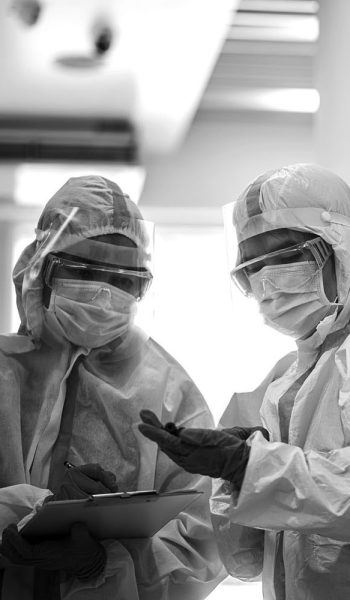 Asian doctor holding checking coronavirus or covid-19 infected patient name list sheet in quarantine area in hospital