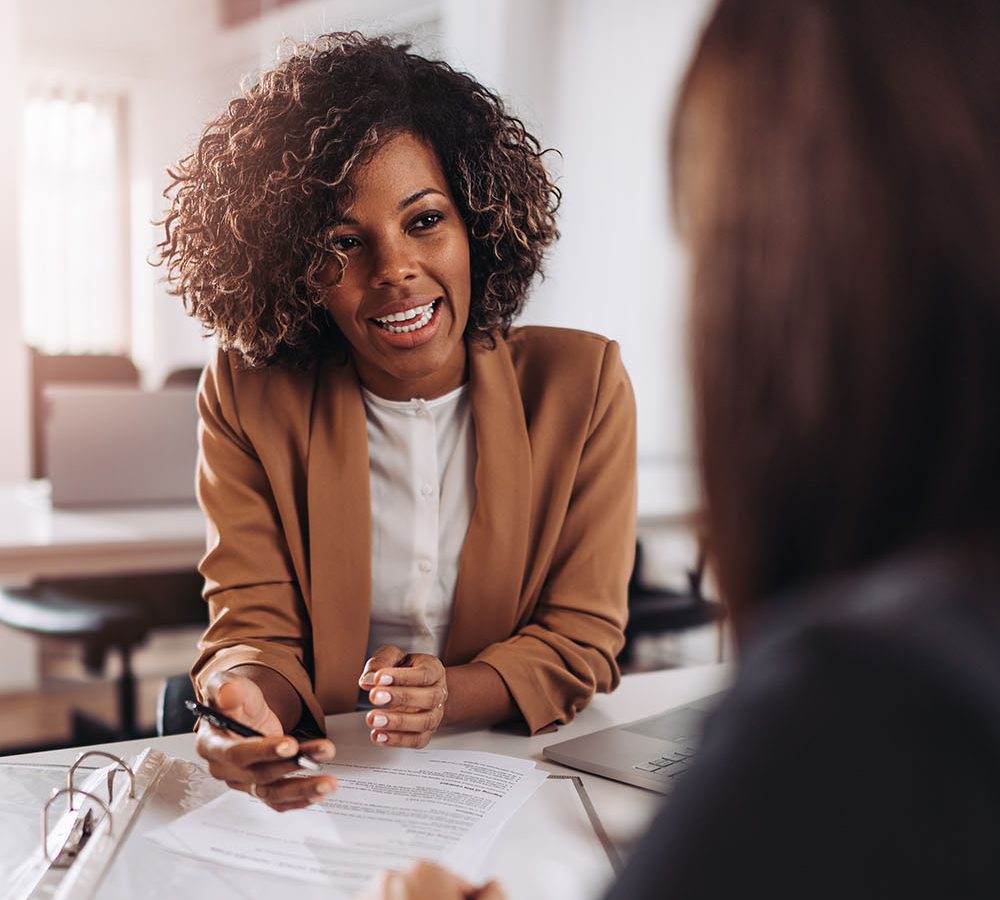 Young woman doing a job interview in the office and talking with client