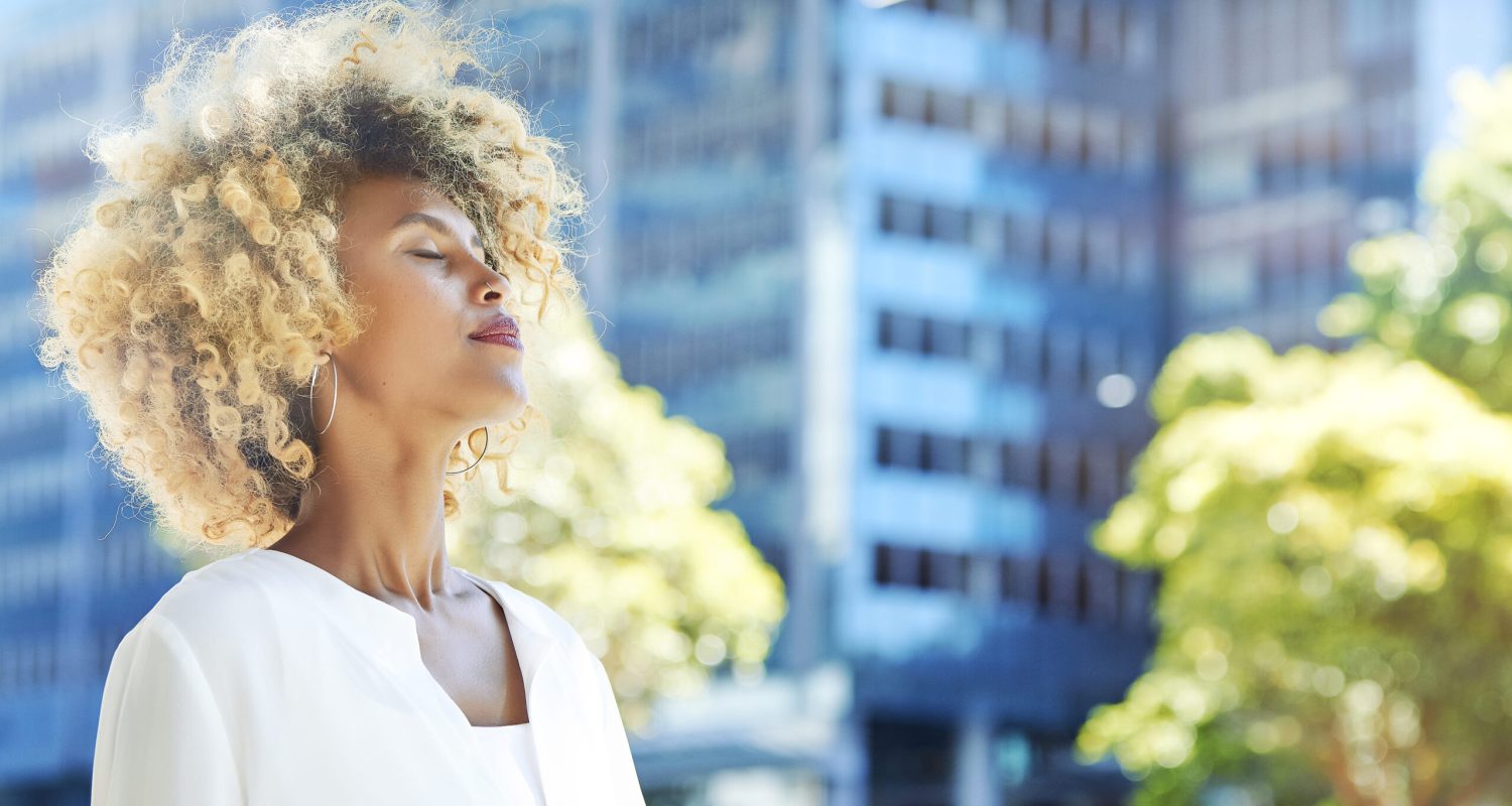 Beautiful businesswoman relaxing outdoor with blue building in the background