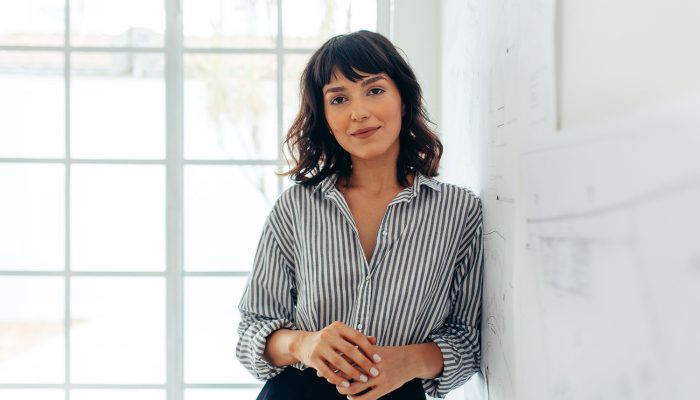 Businesswoman standing in office. Portrait of a confident businesswoman.