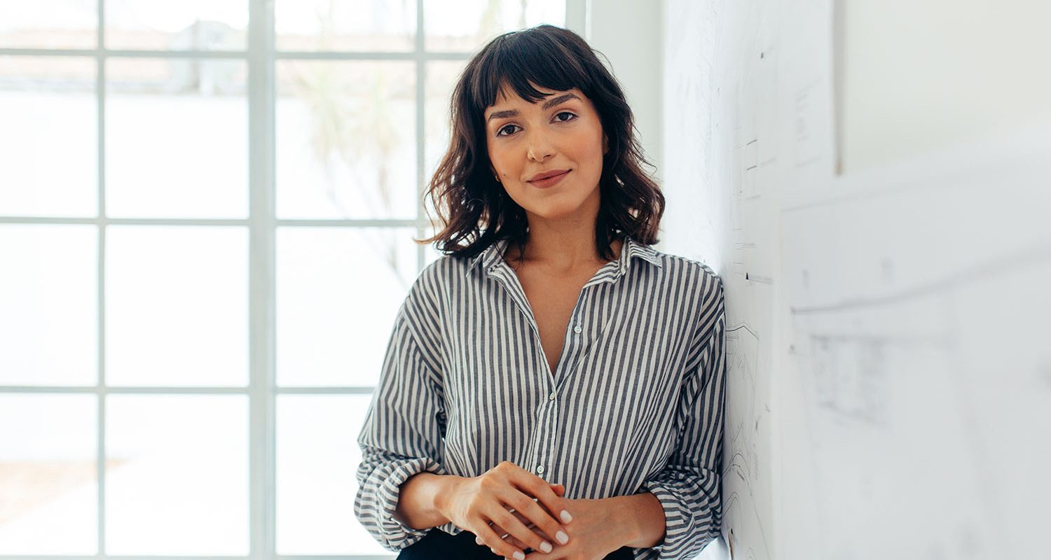 Businesswoman standing in office. Portrait of a confident businesswoman.