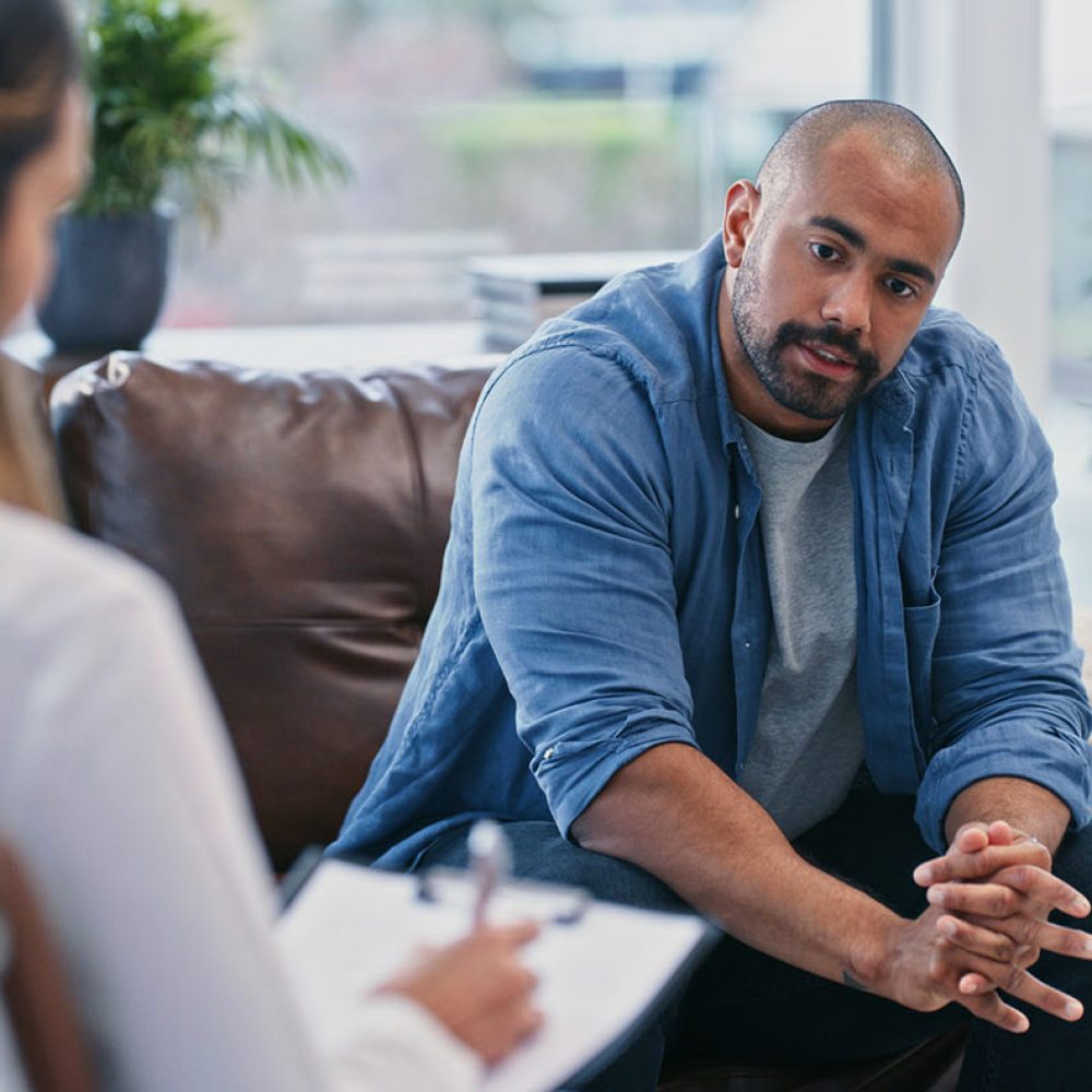 Cropped shot of a handsome young man looking thoughtful while sitting in session with his female therapist Where do I begin?