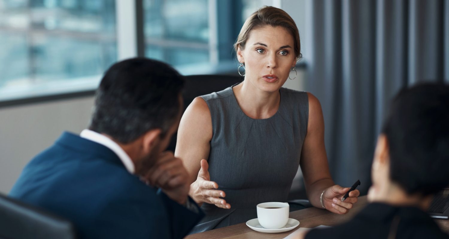 Serious woman talking to business clients in meeting negotiation, legal advice or professional advisory planning. Lawyer, manager or corporate people in conference room discussion for career strategy