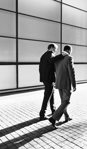 Businessmen talking on city street