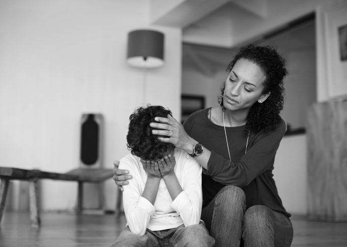 Cropped shot of a mother comforting her little son at home
