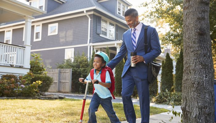 Businessman Father Walking Son On Scooter To School